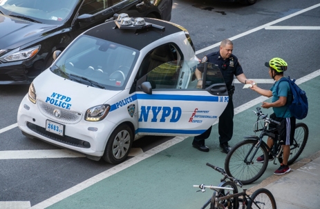 Police Officer giving a bicyclist a ticket